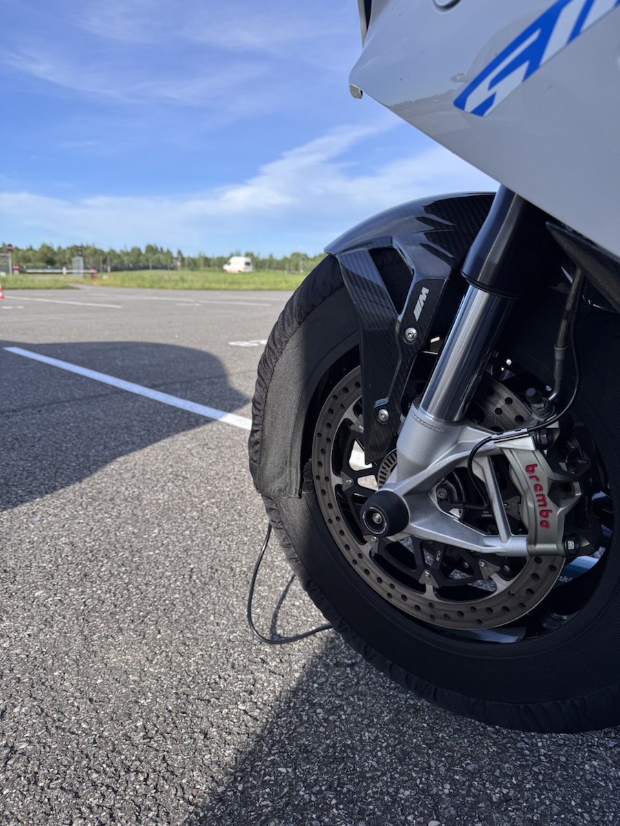 Front Brembo caliper and carbon fender with tyre warmer fitted