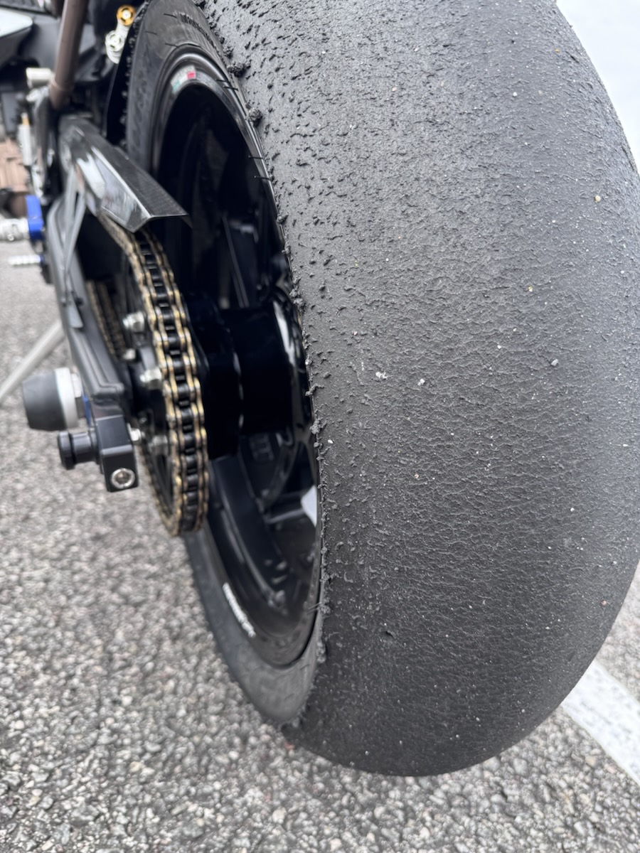 Rear slick after a session, surface torn and rolled