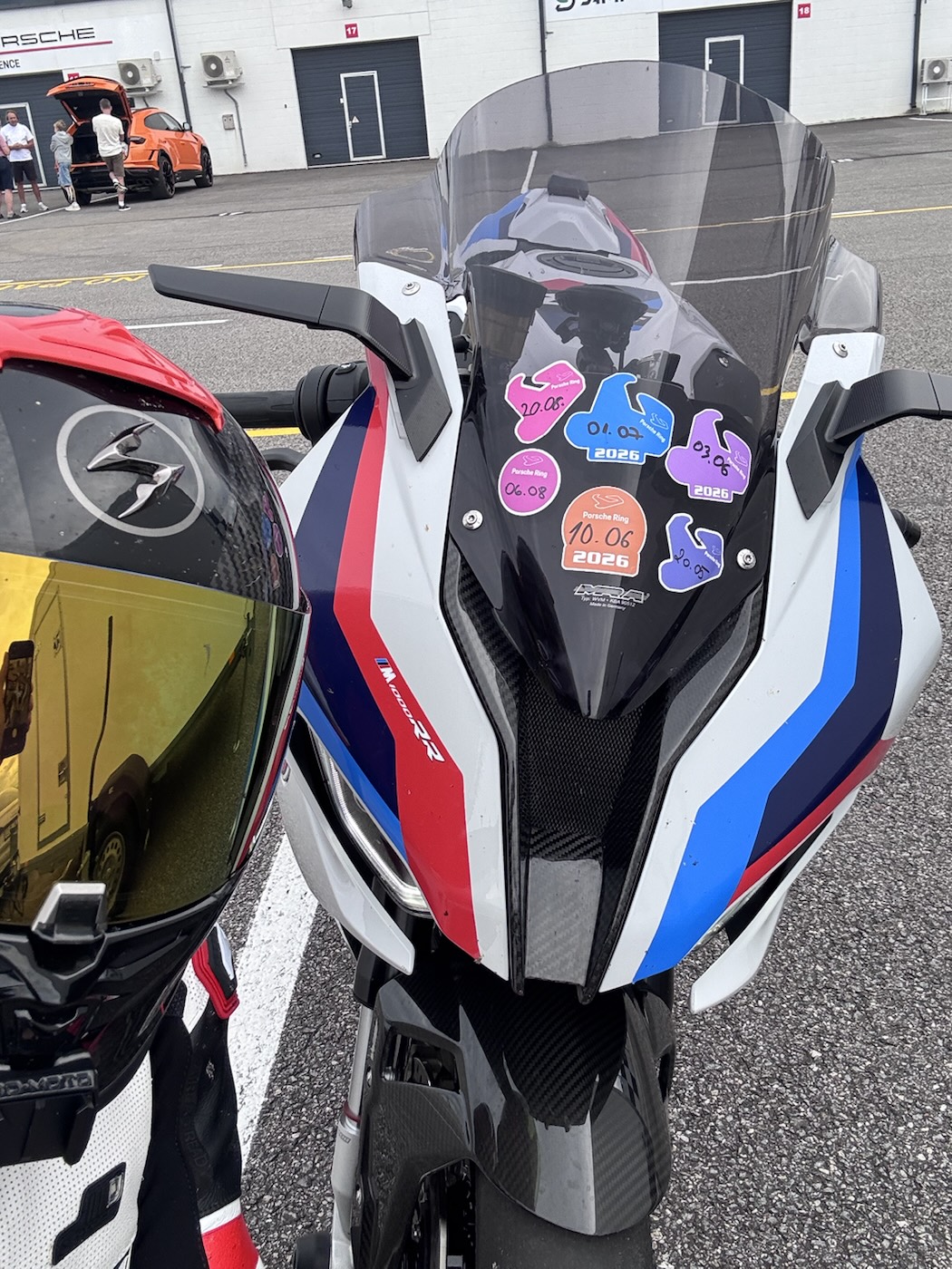 Porsche Ring day stickers on the bike's windscreen: 20.05, 03.06, 10.06 and 01.07 2026