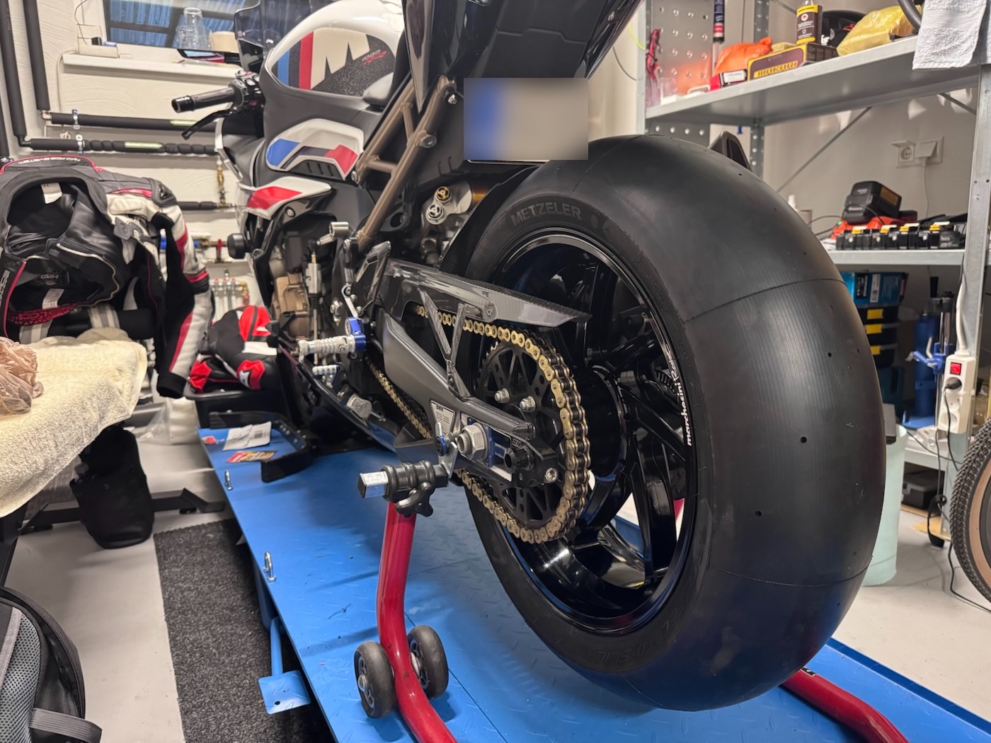 Metzeler slick on the rear wheel, bike on a paddock stand in the workshop